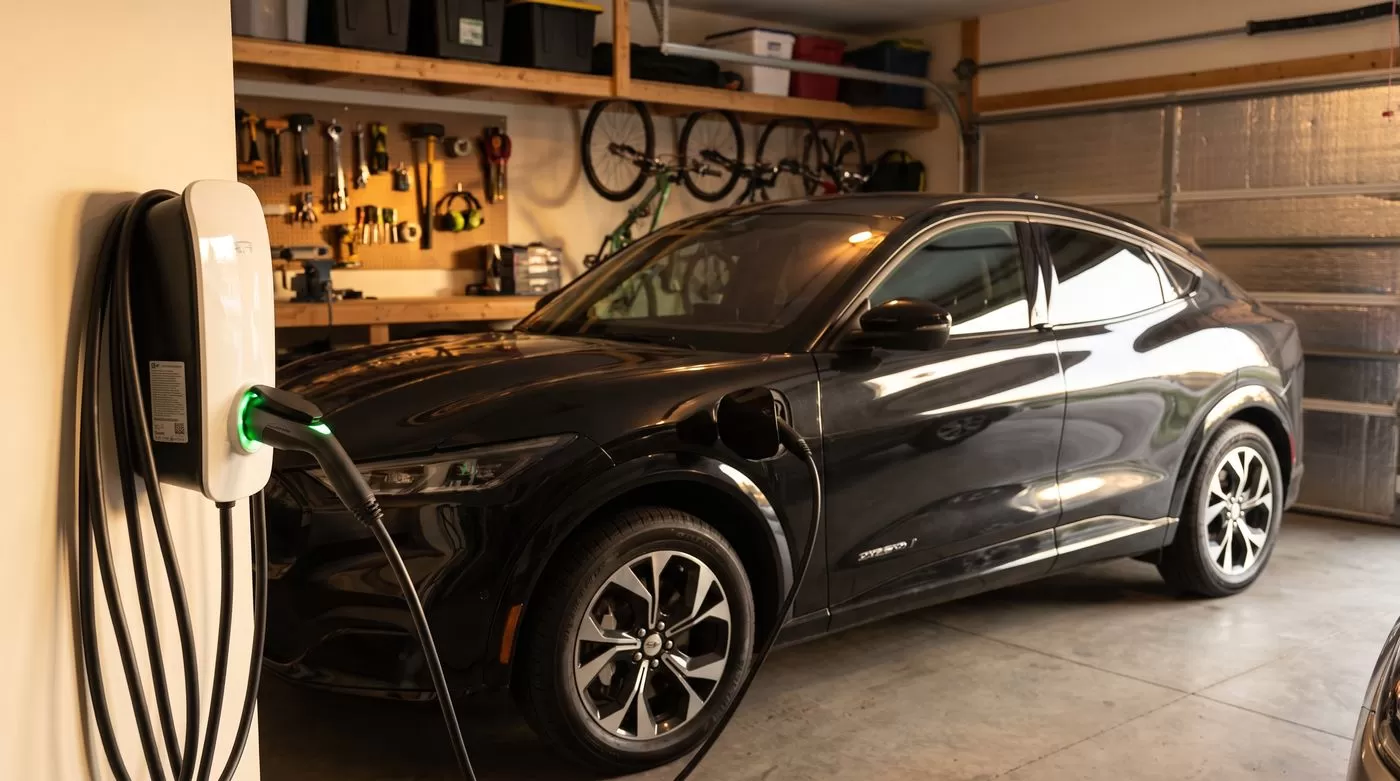 Level 2 EV charger charging an electric vehicle in a home garage